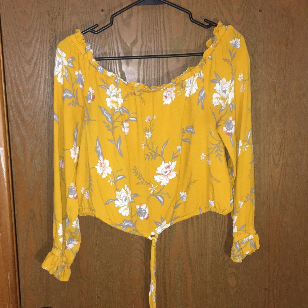 An off the shoulder yellow blouse.